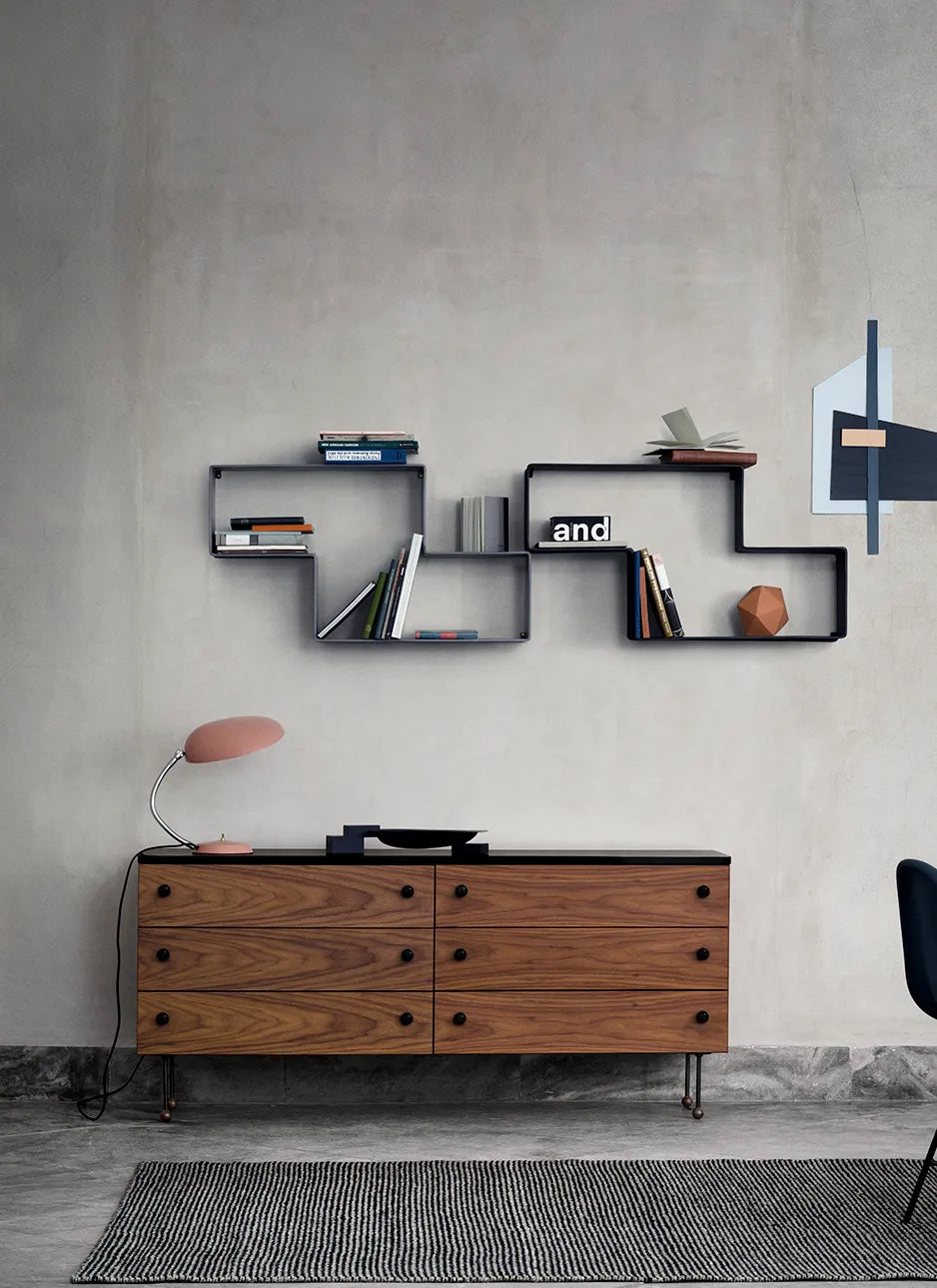 Gubi 62 Sideboard with 6 drawers in a bedroom setting, showcasing sleek modern design and wood finish.
