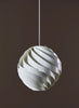 Large Gubi Turbo Pendant lighting fixture with sleek, modern design and matte finish, hanging from a ceiling.