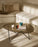 Gubi Pedrera coffee table with chrome frame and smoke-colored structured glass top, modern and stylish living room centerpiece.