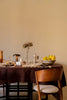 Handloom tablecloth by Lorena Canals featuring a vibrant, woven pattern in natural tones, draped over a table for a stylish look.