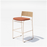 Hinoki counter stool by Bend Goods with a tan wooden seat and black metal legs, modern seating for kitchen or bar area.