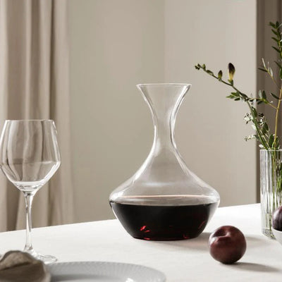 Holmegaard Perfection carafe with matching holder, elegant glass accessories for serving beverages in a sophisticated style.