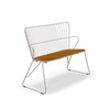 White PAON bench by Houe, modern seating with sleek wooden legs and a smooth, curved seat for contemporary outdoor or indoor use.