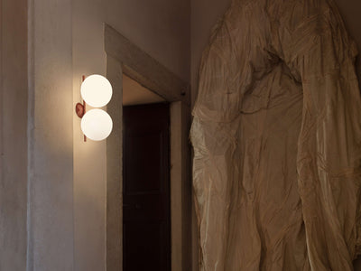 Red and burgundy Flos IC Lights Ceiling/Wall Double lighting fixture installed on wall and ceiling, featuring sleek modern design.