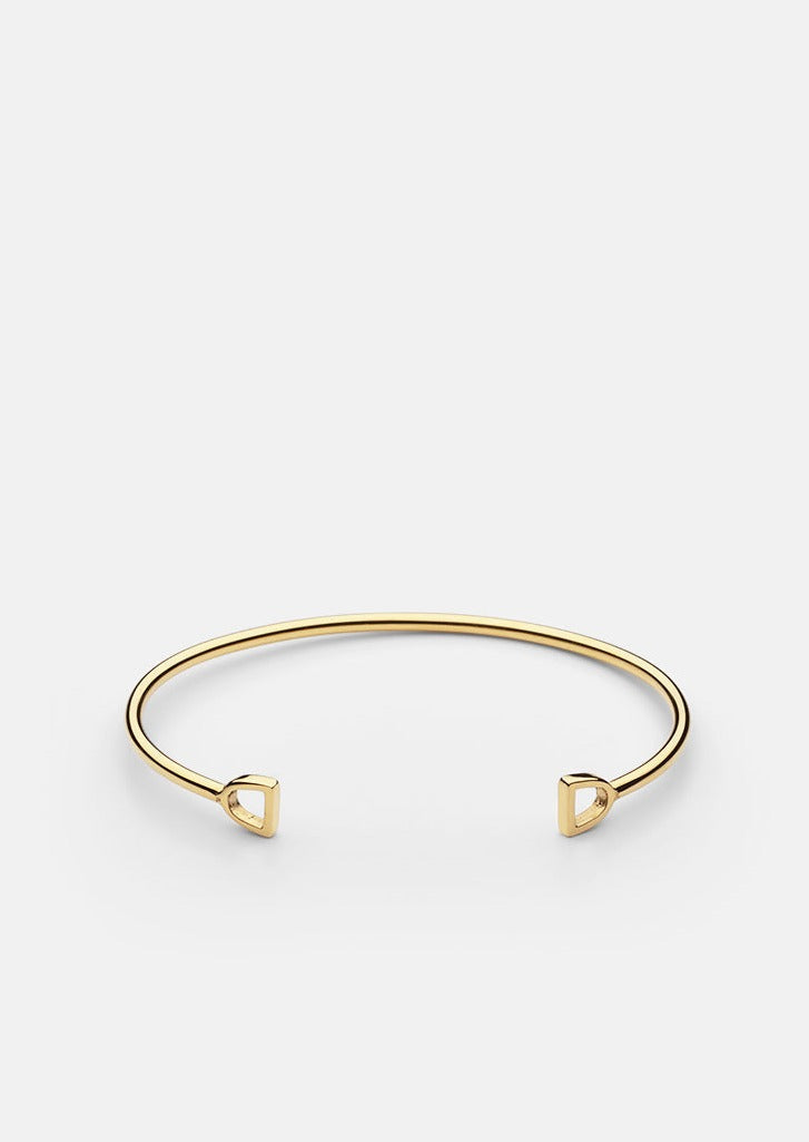 Gold plated GTG Stirrup Cuff by Skultuna, a stylish accessories bracelet with a sleek stirrup design.