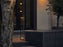 Modern Flos In Vitro Bollard 3 outdoor lighting fixture with sleek design and durable metal finish, illuminated at night.