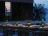 Green Bellhop Portable Table Lamp by Flos, modern lighting with a sleek design, unplugged on a neutral background.