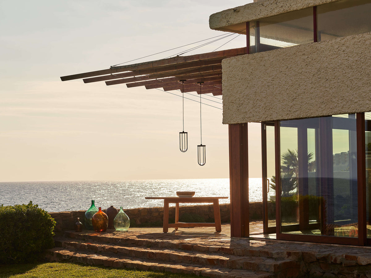Outdoor In Vitro Suspension lighting fixture by Flos, featuring sleek modern design with a white diffuser and metal frame.