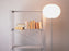 Modern Glo-Ball Floor lamp by Flos in a stylish living room, featuring a spherical glass shade and sleek metal stand.