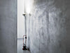 Red Toio Floor Lamp by Flos in a modern living space, showcasing its sleek design and adjustable lighting features.