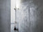 Red Toio Floor Lamp by Flos in a modern living space, showcasing its sleek design and adjustable lighting features.
