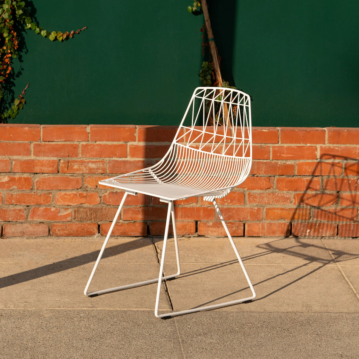Lucy Chair by Bend Goods, stylish modern seating with curved design, shown as a dining or lounge chair in a contemporary setting.