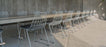 Stacked Lucy seating by Bend Goods showing modern, stackable metal chairs with curved backs and sleek design.