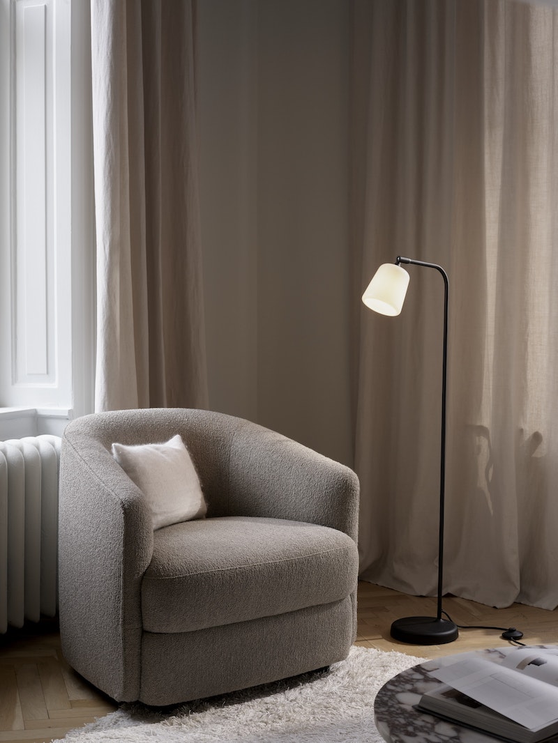 Material Floor Lamp by New Works featuring natural cork shade and sleek lighting design for modern interior spaces.