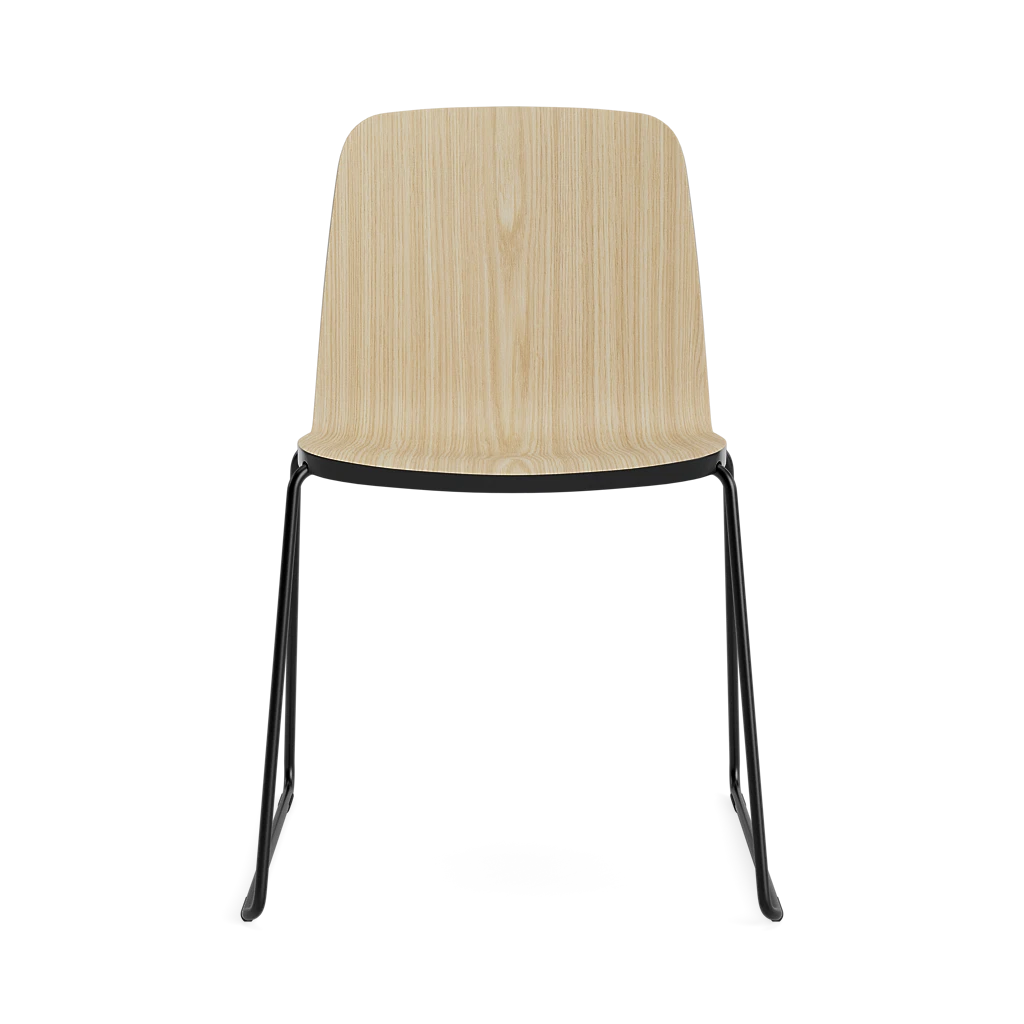 Black steel Just Chair seating by Normann Copenhagen with a sleek modern design, featuring a curved backrest and sturdy frame.