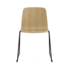 Black steel Just Chair by Normann Copenhagen, modern seating with sleek design and wooden armrests, suitable for contemporary interiors.