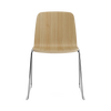 Black steel Just Chair by Normann Copenhagen, modern seating with a sleek design and wooden ash legs, suitable for contemporary interiors.