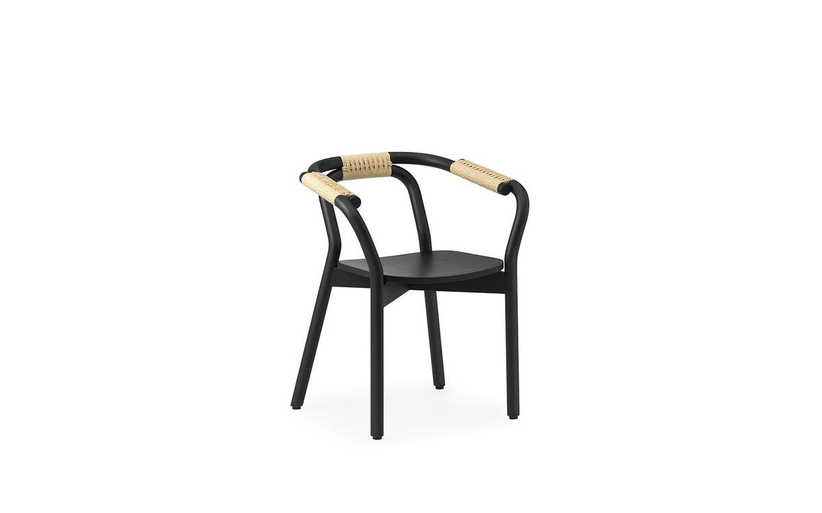 Black Knot seating by Normann Copenhagen featuring a woven design and natural wood legs.