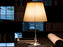 KTribe Table by Flos lighting fixture with fabric shade, modern design, and sleek base, ideal for contemporary living spaces.