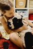 Kids' Lola the Cow pouf by Lorena Canals featuring a soft, plush cow design with black and white spots, perfect for children's room decor.