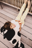 Kids' Lola the Cow pouf by Lorena Canals featuring a soft, plush cow design perfect for children's room decor.
