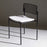 Bend Goods Rachel Chair in black metal with woven seat, modern seating piece with sleek design and curved backrest.