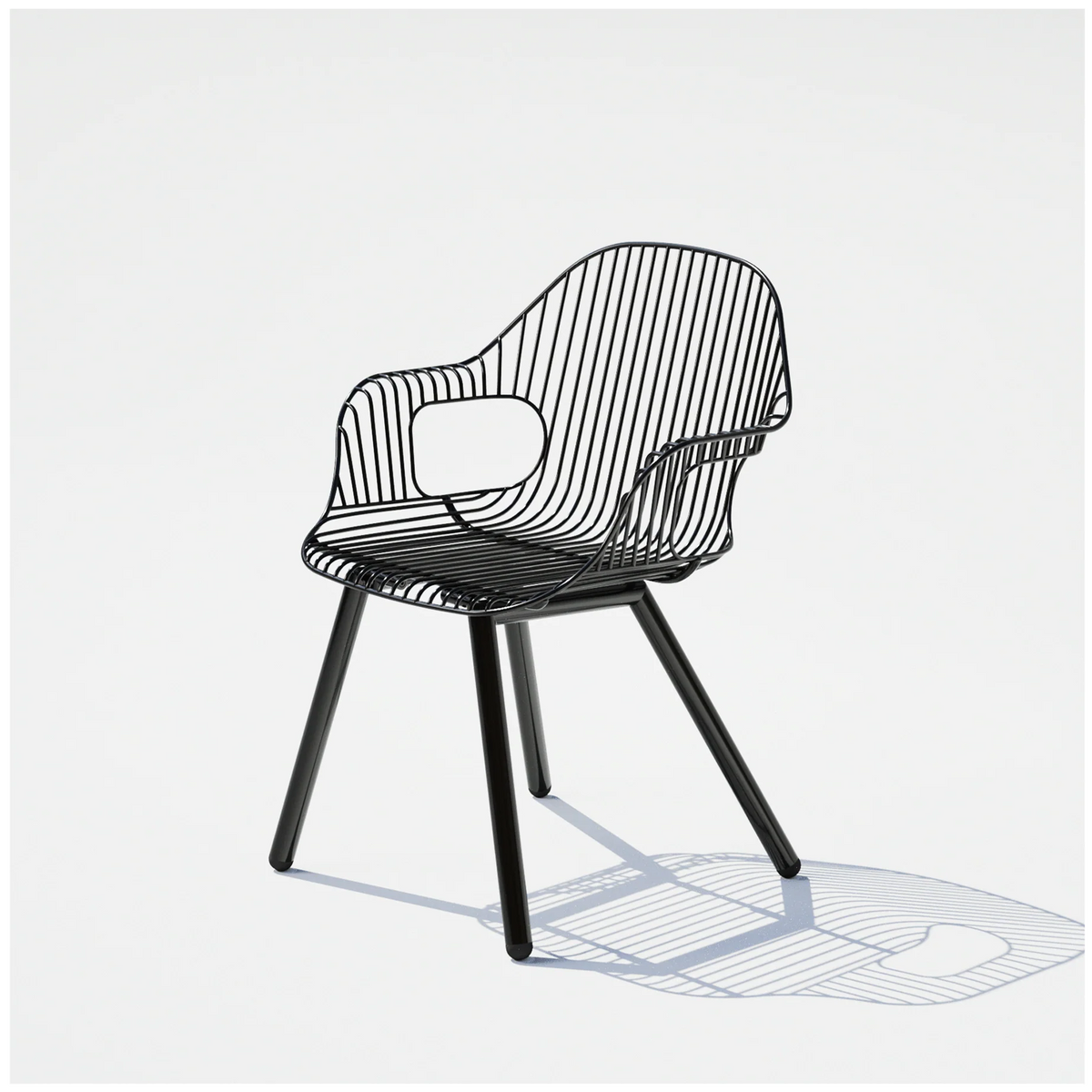 Black Rita chair by Bend Goods featuring a modern, curved metal armrest and sleek seating design.