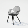 Black Rita chair by Bend Goods featuring a modern, curved metal armrest and sleek seating design.