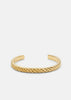 Gold plated Scale Cuff bracelet by Skultuna, featuring a sleek, modern design in a close-up image of the stylish accessory.