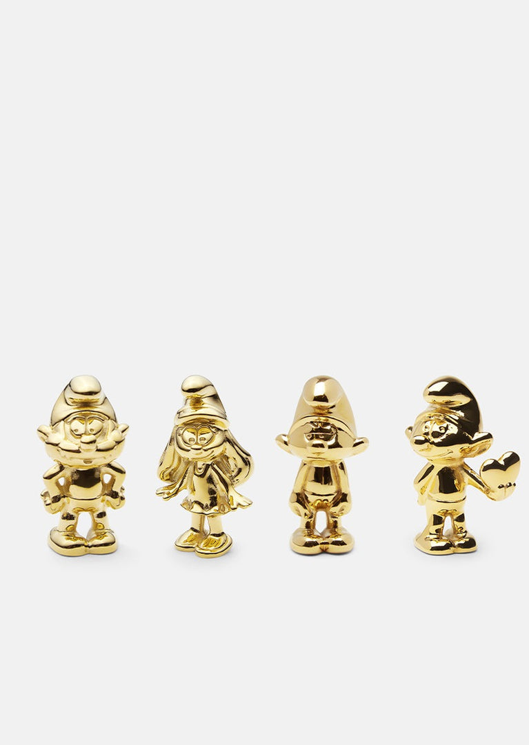 Set of four Smurfs accessories in Skultuna giftbox, featuring detailed blue Smurf figures with white hats and accessories.