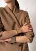 Gold-plated Omega bangle by Skultuna, showcasing a sleek, minimalist accessories design with a smooth finish.