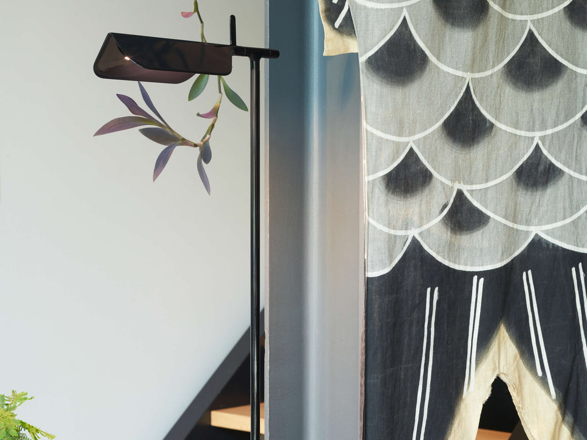 Black Tab Floor lamp by Flos, modern lighting with sleek design, featuring a slim vertical stand and adjustable lamp head.