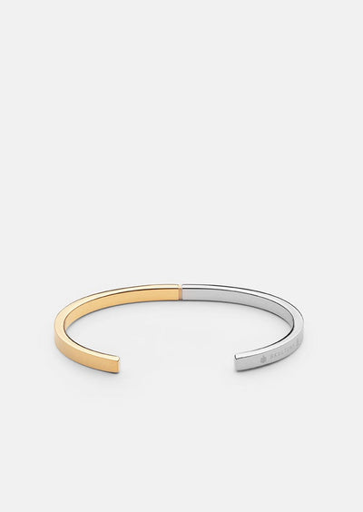 Skultuna SB Cuff Thin two-tone 50/50 accessories featuring sleek, minimalist design with silver and gold finishes.