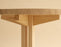 Round Vaarnii 001 Dining Table with wooden surface and sleek legs, ideal for modern dining spaces.