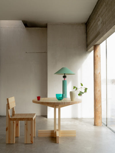 Round Vaarnii dining table with sleek wooden surface, showcasing modern design perfect for contemporary dining spaces.