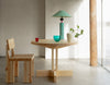 Round Vaarnii 001 dining table with wooden top and sleek design, perfect for modern dining spaces.