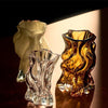 Small Vena Vase by AYTM in amber glass, showcasing its elegant, modern design for decorative accessories.