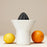 Rig-Tig orange squeezer accessory for citrus juicing, featuring a vibrant orange design and ergonomic handle.