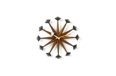 Vitra Polygon clock accessory featuring a geometric, multicolored design with a round face and modern style.