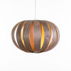 Ruth Small Pendant light by Atelier Cocotte featuring a white oak and birch wood shade with a minimalist design.