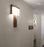 Dark stained walnut Oris wall sconce by Cerno with 2700K LED, American-made lighting fixture mounted on wall.