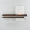 Levo wall sconce by Cerno with cord, modern lighting fixture made in USA, featuring sleek design and natural wood finish.