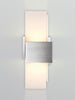 Oiled walnut Acuo Wall Sconce by Cerno, modern lighting fixture with LED, made in USA, mounted on wall with warm glow.