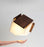 Cerno Mica LED pendant light in oiled walnut wood with warm 2700K glow, American-made lighting fixture.