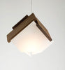 Cerno Mica LED pendant light in oiled walnut wood, showcasing modern lighting design with warm 2700K LED illumination.