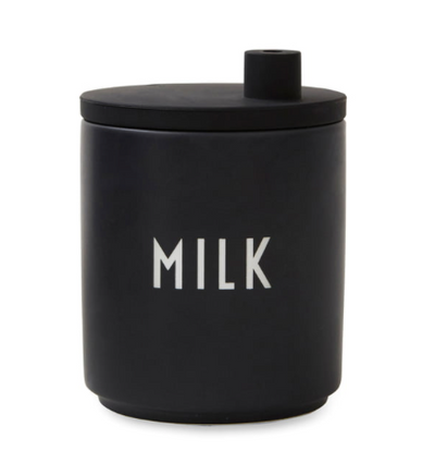 Black porcelain milk jug with silicone lid by Design Letters, designed as an stylish kitchen accessory.