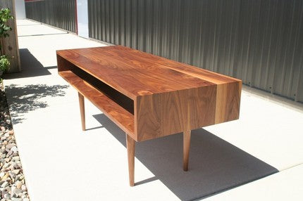 Walnut Classic Coffee Table by Eastvold Furniture featuring a sleek design with nine sturdy legs and a smooth tabletop.