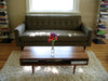 Walnut classic coffee table with nine legs by Eastvold Furniture, showcasing a sleek, modern design in a living room setting.