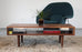 Walnut classic coffee table by Eastvold Furniture featuring nine legs and a sleek, modern design.