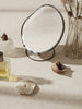 Ferm Living Brass Pond Table Mirror in accessories collection, featuring a round brass frame and reflective surface.